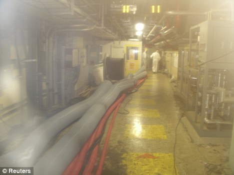 Nuclear disaster: Workers walking inside Fukushima Daiichi nuclear power plant Unit 2 reactor turbine building in Fukushima, northern Japan